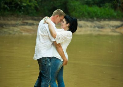 couple embrace in mud pool
