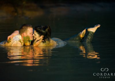 couple lying in mud pool