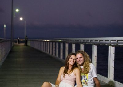 Couple sitting on pier