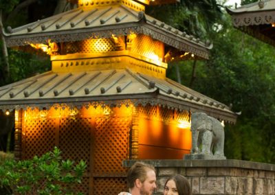 Couple embrace in front of Taoist temple
