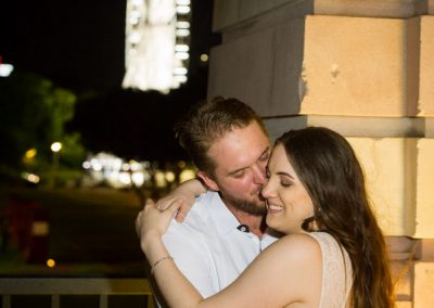 Couple hug in front of Wheel of Brisbane
