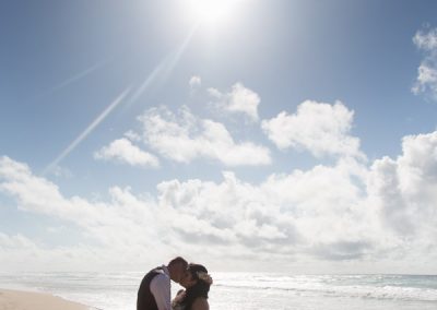 Bride and Groom kiss on the beach